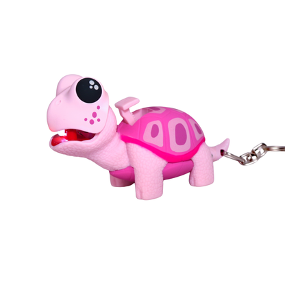 Pink turtle-shaped keychain with a keyring on a white background
